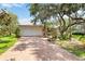 Charming home with a brick driveway, well-manicured landscaping, and a two-car garage at 4443 Robin Hood W Trl, Sarasota, FL 34232
