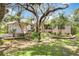 Beautiful home with lush landscaping, mature trees, and charming curb appeal at 4443 Robin Hood W Trl, Sarasota, FL 34232