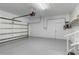 Spacious garage featuring painted floor, an automatic door, and a service door at 4443 Robin Hood W Trl, Sarasota, FL 34232