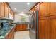 A view of the updated kitchen with modern stainless steel appliances and stone countertops at 4443 Robin Hood W Trl, Sarasota, FL 34232