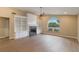 Spacious living room with a fireplace, built-in bookshelves, and a large window at 4443 Robin Hood W Trl, Sarasota, FL 34232