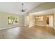 Open living space with wood floors, a chandelier, and a bright window at 4443 Robin Hood W Trl, Sarasota, FL 34232