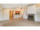 Living room featuring wood floors, ceiling fan, fireplace and a view into the kitchen at 4443 Robin Hood W Trl, Sarasota, FL 34232