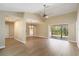 Spacious living area with modern floors, chandelier, and slider to lanai at 4443 Robin Hood W Trl, Sarasota, FL 34232