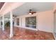 Enclosed outdoor patio featuring ceramic tile flooring and ceiling fans for comfortable outdoor living at 4443 Robin Hood W Trl, Sarasota, FL 34232