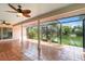 Covered patio with tile flooring and screened in walls overlooking a lake at 4443 Robin Hood W Trl, Sarasota, FL 34232