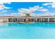Community pool with covered seating area overlooking the water at 4509 Dusky Dawn Ln, Palmetto, FL 34221