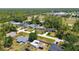 An aerial view shows a well-maintained neighborhood with mature trees and green spaces at 4664 Hegira St, North Port, FL 34286