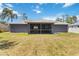 The backyard features a screened-in lanai and a well-maintained lawn at 4664 Hegira St, North Port, FL 34286