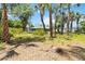 The backyard features mature trees, lush vegetation, and a lush lawn at 4664 Hegira St, North Port, FL 34286