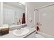 Clean bathroom featuring shower-tub combo, white vanity, and decorative hand towels at 4664 Hegira St, North Port, FL 34286