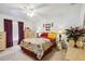 Comfortable bedroom with ceiling fan, side tables with lamps, and large dresser at 4664 Hegira St, North Port, FL 34286