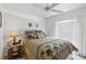 Bright bedroom with ceiling fan, bedside lamps, large window, and unique side table at 4664 Hegira St, North Port, FL 34286