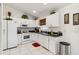 Well-maintained kitchen featuring white cabinets, black countertops, and modern appliances, offering functionality and style at 4664 Hegira St, North Port, FL 34286