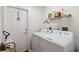 Functional laundry room featuring washer, dryer, storage shelf, and access to outdoors at 4664 Hegira St, North Port, FL 34286