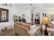 Bright living room with comfortable seating, a glass coffee table, and an open view to the dining area at 4664 Hegira St, North Port, FL 34286