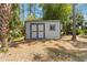 This backyard features a storage shed with double doors and one window at 4664 Hegira St, North Port, FL 34286