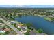 Panoramic aerial view of the neighborhood, featuring houses nestled along a scenic lake and lush greenery at 4708 26Th W Ave, Bradenton, FL 34209