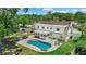 Aerial view of the home's backyard, showcasing the kidney-shaped pool, screened-in porch, and outdoor seating area at 4708 26Th W Ave, Bradenton, FL 34209
