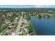 Picturesque aerial view of a charming neighborhood bordering a serene lake, highlighting waterfront living at 4708 26Th W Ave, Bradenton, FL 34209