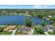Aerial view of home on a large lake lot with sprawling yard, neighboring homes, and lush landscaping at 4708 26Th W Ave, Bradenton, FL 34209