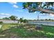 Waterfront backyard with a swing, fire pit, and ample space for recreation, providing a serene outdoor oasis at 4708 26Th W Ave, Bradenton, FL 34209