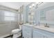 Well-lit bathroom with double sinks and tiled glass shower at 4708 26Th W Ave, Bradenton, FL 34209