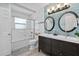 Bright bathroom featuring double vanity sinks, a shower and bath, and stylish tiling at 4708 26Th W Ave, Bradenton, FL 34209