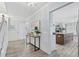 Inviting entryway featuring light wood-look tile floors and views of the kitchen at 4708 26Th W Ave, Bradenton, FL 34209