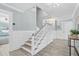 Hallway with stairs leading to the second floor, showing detailed wainscoting and trim work at 4708 26Th W Ave, Bradenton, FL 34209