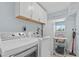 Efficient laundry room with washer, dryer, and storage cabinets at 4708 26Th W Ave, Bradenton, FL 34209