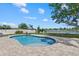 Sparkling kidney-shaped pool with a brick patio and views of the lake at 4708 26Th W Ave, Bradenton, FL 34209