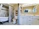 Updated bathroom with bathtub, marble tile, double sink vanity, and modern fixtures at 4873 Huntleigh Dr, Sarasota, FL 34233