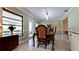 Traditional dining room with ornate wood table, decorative chairs, and access to screened porch at 4873 Huntleigh Dr, Sarasota, FL 34233