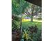 Beautiful yard features manicured lawn, a mix of shrubbery, and a shady tree at 4873 Huntleigh Dr, Sarasota, FL 34233