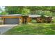 Inviting home featuring lovely landscaping, a two-car garage and a welcoming entrance, perfect for any Gathering at 4873 Huntleigh Dr, Sarasota, FL 34233