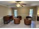 Bright living room with neutral paint, tile flooring, ceiling fan, and modern furniture at 4873 Huntleigh Dr, Sarasota, FL 34233
