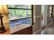 View to outdoor patio area from inside the home with screened window at 4873 Huntleigh Dr, Sarasota, FL 34233