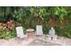 Secluded brick patio featuring an outdoor seating area surrounded by lush greenery at 4873 Huntleigh Dr, Sarasota, FL 34233