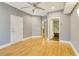 Neutral bedroom features hardwood floors, neutral gray paint, access to two bathrooms, and a ceiling fan at 5168 Northridge Rd # 106, Sarasota, FL 34238