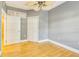 Bedroom with hardwood floors features closet and transom window for extra light at 5168 Northridge Rd # 106, Sarasota, FL 34238
