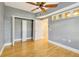 Bedroom with hardwood floors features closet and transom window for extra light at 5168 Northridge Rd # 106, Sarasota, FL 34238