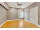 Unfurnished room features hardwood floors, neutral gray paint, a ceiling fan, and a window with shutters at 5168 Northridge Rd # 106, Sarasota, FL 34238