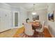 Light-filled dining room shows hardwood floors, modern lighting, and a dining table with seating for six at 5168 Northridge Rd # 106, Sarasota, FL 34238