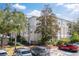 Building exterior showing a neutral color scheme, multiple windows, and mature trees in a parking lot at 5168 Northridge Rd # 106, Sarasota, FL 34238