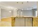 Kitchen island boasts granite countertop, stainless steel dishwasher, and opens to the living area at 5168 Northridge Rd # 106, Sarasota, FL 34238