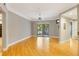 Spacious living area with sliding doors to a balcony and wood floors at 5168 Northridge Rd # 106, Sarasota, FL 34238