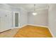 Bright living room featuring hardwood floors, crown molding, contemporary lighting, and a glass-paneled door at 5168 Northridge Rd # 106, Sarasota, FL 34238
