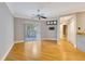 Neutral living room with wood floors, ceiling fan, and large window offering natural light at 5168 Northridge Rd # 106, Sarasota, FL 34238
