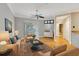 Neutral living room with wood floors, ceiling fan, and large window offering natural light at 5168 Northridge Rd # 106, Sarasota, FL 34238